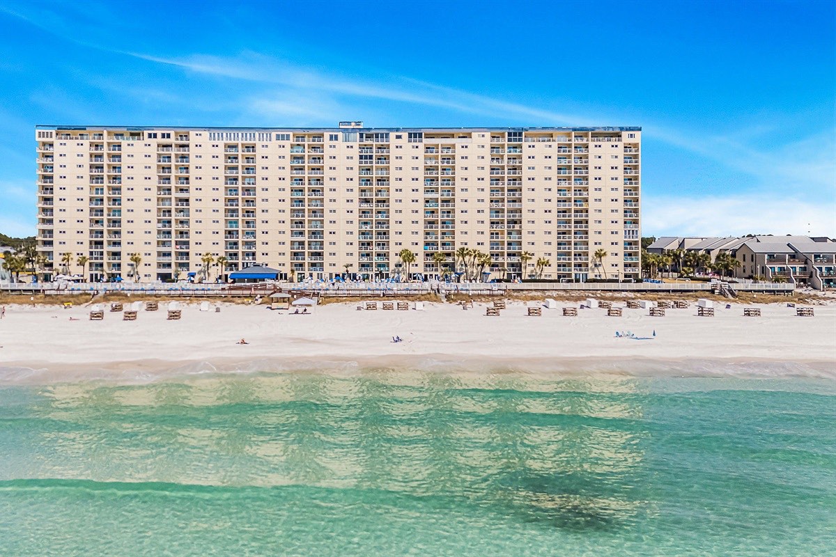 Morning walks along the surf start here, with soft sand underfoot and your beachside stay rising just behind you.