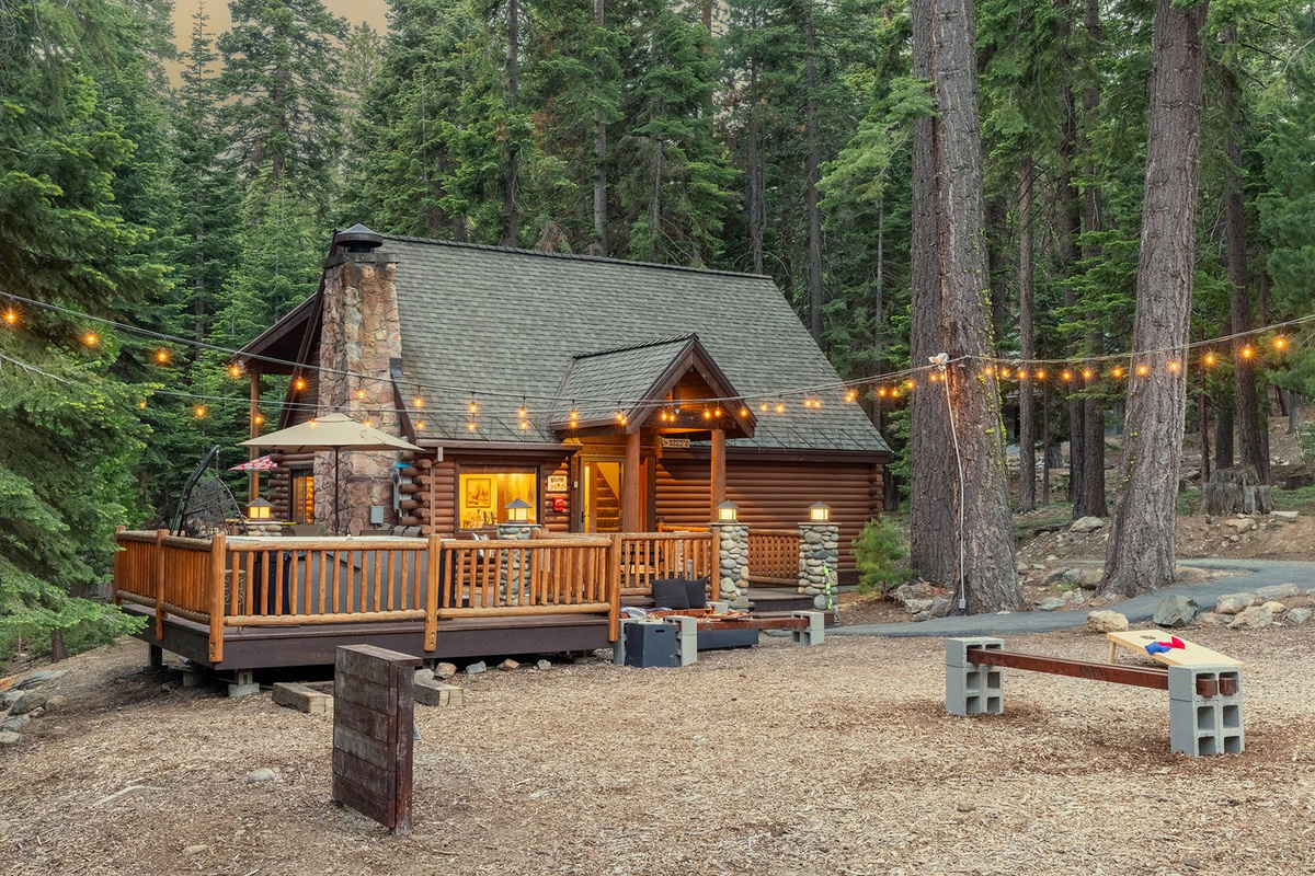 A log cabin in the pines above Lake Tahoe at dusk