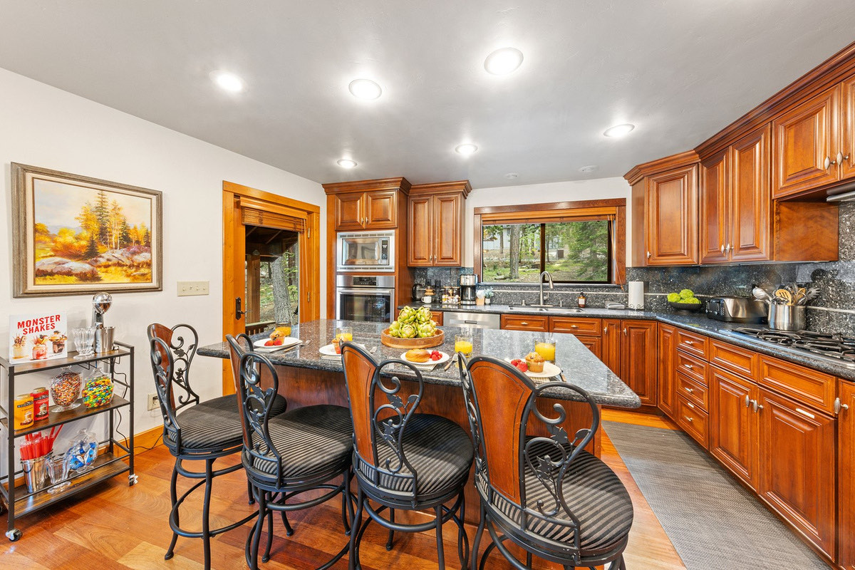 Cook for a crowd in the island kitchen — bar seating for four, breakfast spread out, and the milkshake bar parked right beside it.
